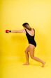 © Ivan Zelenin - Woman do high kick, tae-bo. Athletic fit female with perfect body kick air, punching with legs