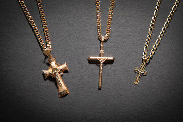 golden cross necklace on the black background.