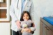 © AntonioDiaz - Adorable child patient with a teddy bear with a doctor
