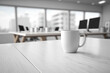 © Nevereski - Coffee cup on the empty office table with a blurred office background