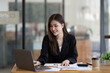 © Parichat - Portrait of young Asian businesswoman working with laptop computer in the office room.