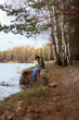 © Елена Вырыпаева - sad lonely man sitting on the river bank in the forest