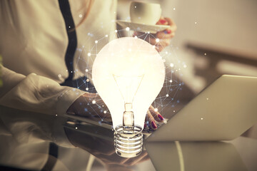 Poster - Double exposure of woman hands typing on computer and light bulb drawing. Idea concept.
