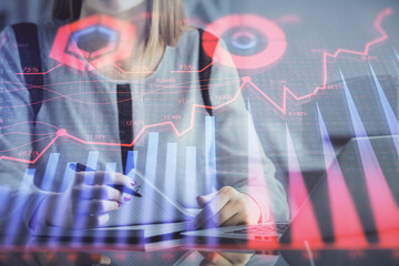 Poster - Double exposure of businesswoman hands typing on computer and financial graph hologram drawing. Stock market analysis concept.