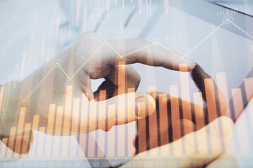 Poster - Multi exposure of man's hands holding and using a phone and financial chart drawing. Market analysis concept.
