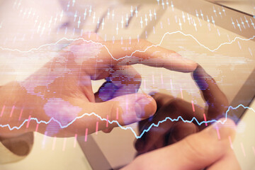 Poster - Multi exposure of man's hands holding and using a phone and financial chart drawing. Market analysis concept.