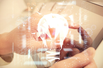 Aufkleber - Double exposure of man's hands holding and using a digital device and bulb hologram drawing. Idea concept.