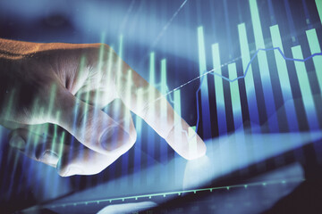 Poster - Multi exposure of man's hands holding and using a phone and financial chart drawing. Market analysis concept.
