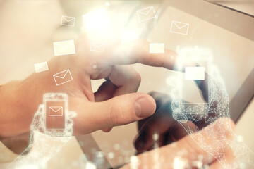 Poster - Double exposure of man's hands holding and using a digital device and envelop hologram drawing. E-mail concept.