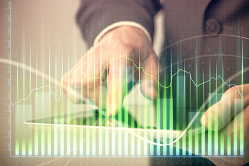 Poster - Multi exposure of man's hands holding and using a phone and financial chart drawing. Market analysis concept.