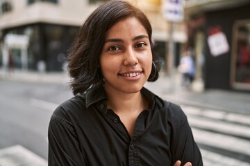 Sticker - Young latin woman smiling confident standing with arms crossed gesture at street