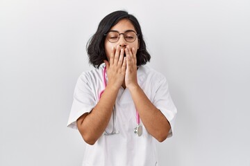 Poster - Young hispanic doctor woman wearing stethoscope over isolated background bored yawning tired covering mouth with hand. restless and sleepiness.