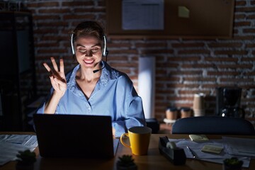 Sticker - Beautiful brunette woman working at the office at night showing and pointing up with fingers number three while smiling confident and happy.