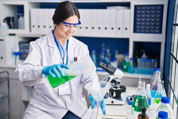 Poster - Young woman scientist measuring liquid at laboratory