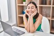 © Krakenimages.com - Young hispanic woman smiling confident sitting on table at home