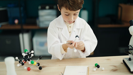 Poster - Adorable hispanic boy student holding molecules toy at laboratory classroom