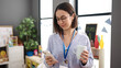 © Krakenimages.com - Young beautiful hispanic woman working as a teacher using smartphone drinking coffee at kindergarten