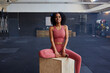 © Flamingo Images - Fit woman sitting on a box at the gym