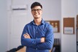 © Krakenimages.com - Young hispanic man business worker smiling confident standing with arms crossed gesture at office