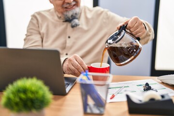 Sticker - Middle age grey-haired man business worker pouring coffee on cup at office