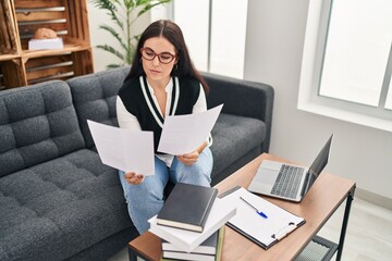 Poster - Young beautiful hispanic woman psychologist reading document at office