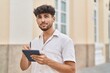 © Krakenimages.com - Young arab man drawing on touchpad standing at street
