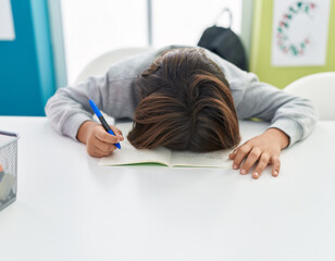 Poster - Adorable hispanic boy student with head on table stressed at classroom