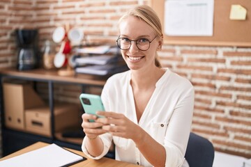 Wall Mural - Young blonde woman business worker using smartphone working at office