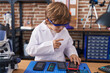 © Krakenimages.com - Adorable caucasian boy scientist repairing smartphone at classroom