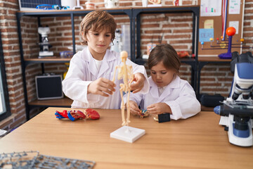 Wall Mural - Brother and sister students having anatomy lesson at laboratory classroom