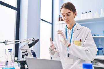 Sticker - Young caucasian woman scientist having video call at laboratory