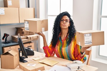 Canvas Print - Middle age hispanic woman working at small business ecommerce looking at the camera blowing a kiss being lovely and sexy. love expression.