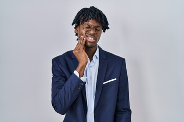 Sticker - Young african man with dreadlocks wearing business jacket over white background touching mouth with hand with painful expression because of toothache or dental illness on teeth. dentist