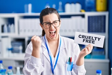 Poster - Young brunette woman working on cruelty free laboratory screaming proud, celebrating victory and success very excited with raised arms