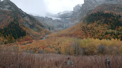 Wall Mural - Inspirational landscape, autumn forest and mountain slopes. Creative. Yellow bright trees and cloudy sky.