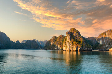 Wall Mural - Halong Bay, Vietnam, with limestone hills and sunset sky. landscape of Ha Long bay with sunset sky, a UNESCO world heritage site and a popular tourist destination.