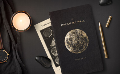 self-care, healing, dreams, moon or astrology themed concept with dream journal, burning scented soy