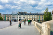 Cyclists at  Pont du Carrousel bridge in Paris. France