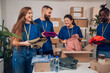 © Zamrznuti tonovi - Diverse volunteers working in a charity donation center and packing clothes and food