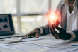© ArLawKa - Businessman hand holding light bulb with natural energy icons, financial documents and tools for inspiration and creativity. Science innovation technology and communication network connection