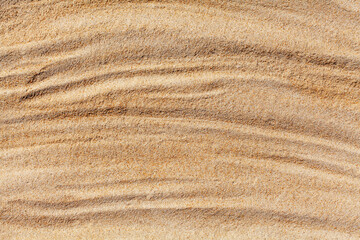 Wall Mural - Wavy yellow sand texture closeup background, sandy waves pattern, natural beige sand grains backdrop, rippled dry sand surface top view, light orange desert dune, summer tropical sea beach, copy space