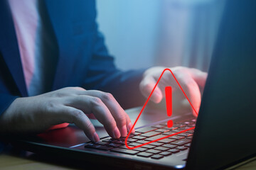Businessman using laptop computer with alerts, warning triangles showing system errors. Concept of system maintenance, security, virus protection and hacking prevention accessing important information