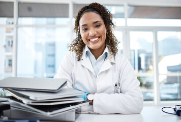 Doctor, documents and portrait of healthcare professional with paperwork on desk or table in the office smile and happy. Medical, research and medicine student studying and learning for knowledge