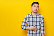 © Bangun Stock Photo - Young handsome Asian man wearing casual clothes keeps his hands on his stomach feeling hungry and wanting to eat delicious isolated on yellow background. People lifestyle concept