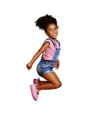 a mixed race cute little girl jumping into the air with her hands raised. happy and carefree kid hop
