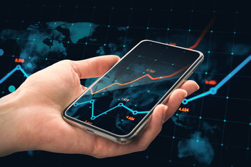Poster - Close up of male hand holding cellphone with glowing business chart and map on dark background. Stock, global growth and financial graph concept. Double exposure.