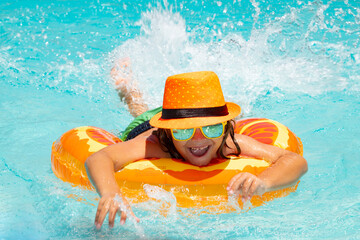 Wall Mural - Children swimming on floating ring in pool. Kids summer portrait. Summer travelling.