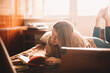 © Cavan Images - Young woman reading book while lying on bed at home