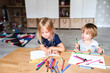 © Cavan Images - Little boy with sister drawing with felt-tip pens