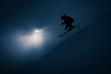 Silhouette Of Man Going Off Jump With Skis And Backpack 55